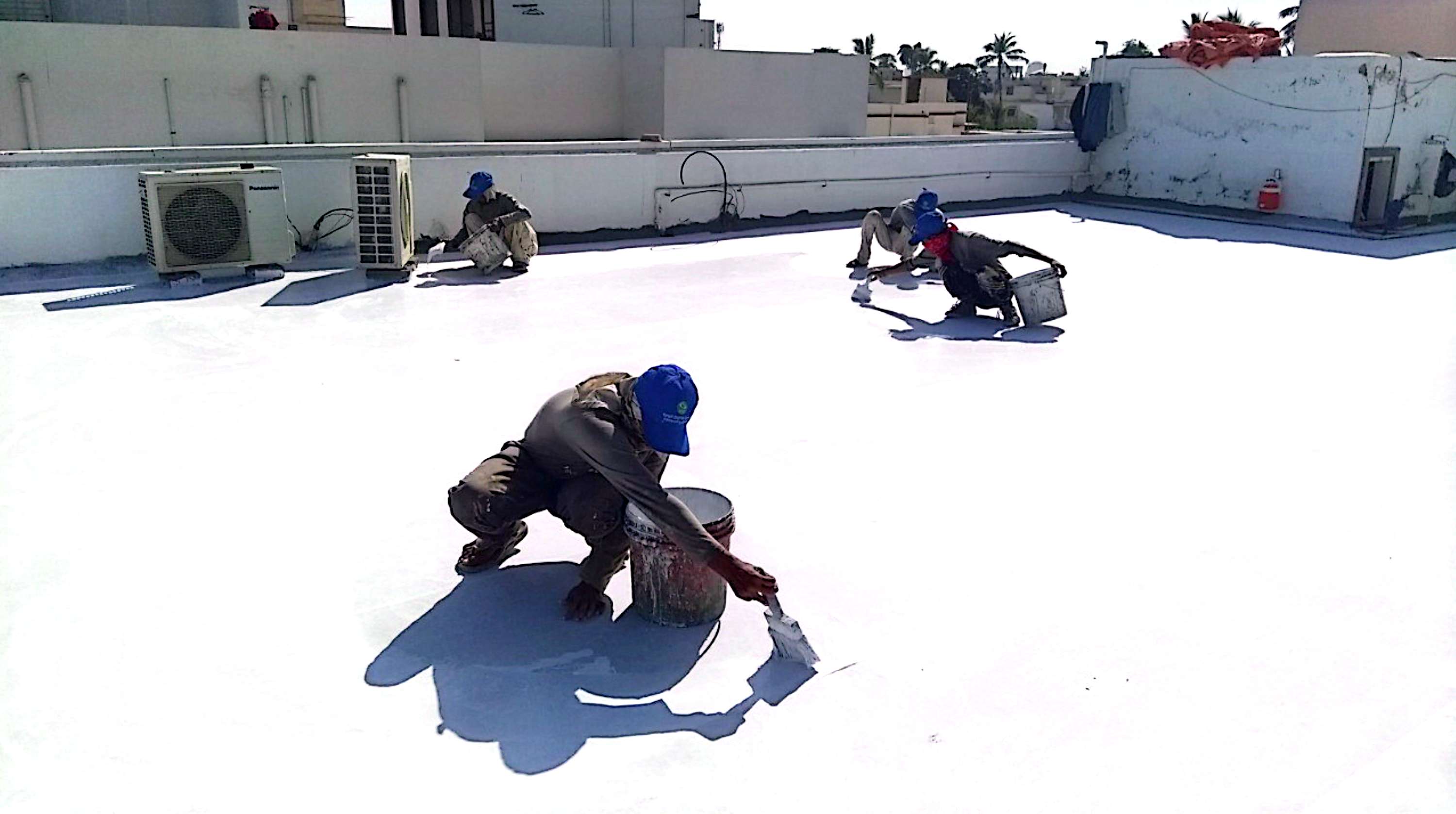 Alpha team applying a waterproofing system on a rooftop